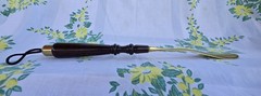Custom made high end long-handled shoe horn. Casten brass and dark wooden handle