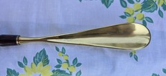 Custom made high end long-handled shoe horn. Casten brass and dark wooden handle