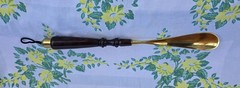 Custom made high end long-handled shoe horn. Casten brass and dark wooden handle
