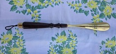 Custom made high end long-handled shoe horn. Casten brass and dark wooden handle