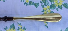 Custom made high end long-handled shoe horn. Casten brass and dark wooden handle